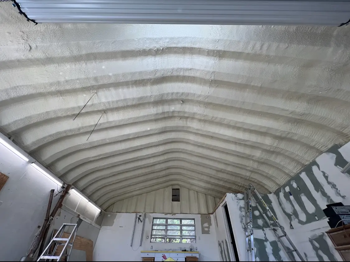 Spray polyurethane foam applied to the underside of a metal roof deck in Media